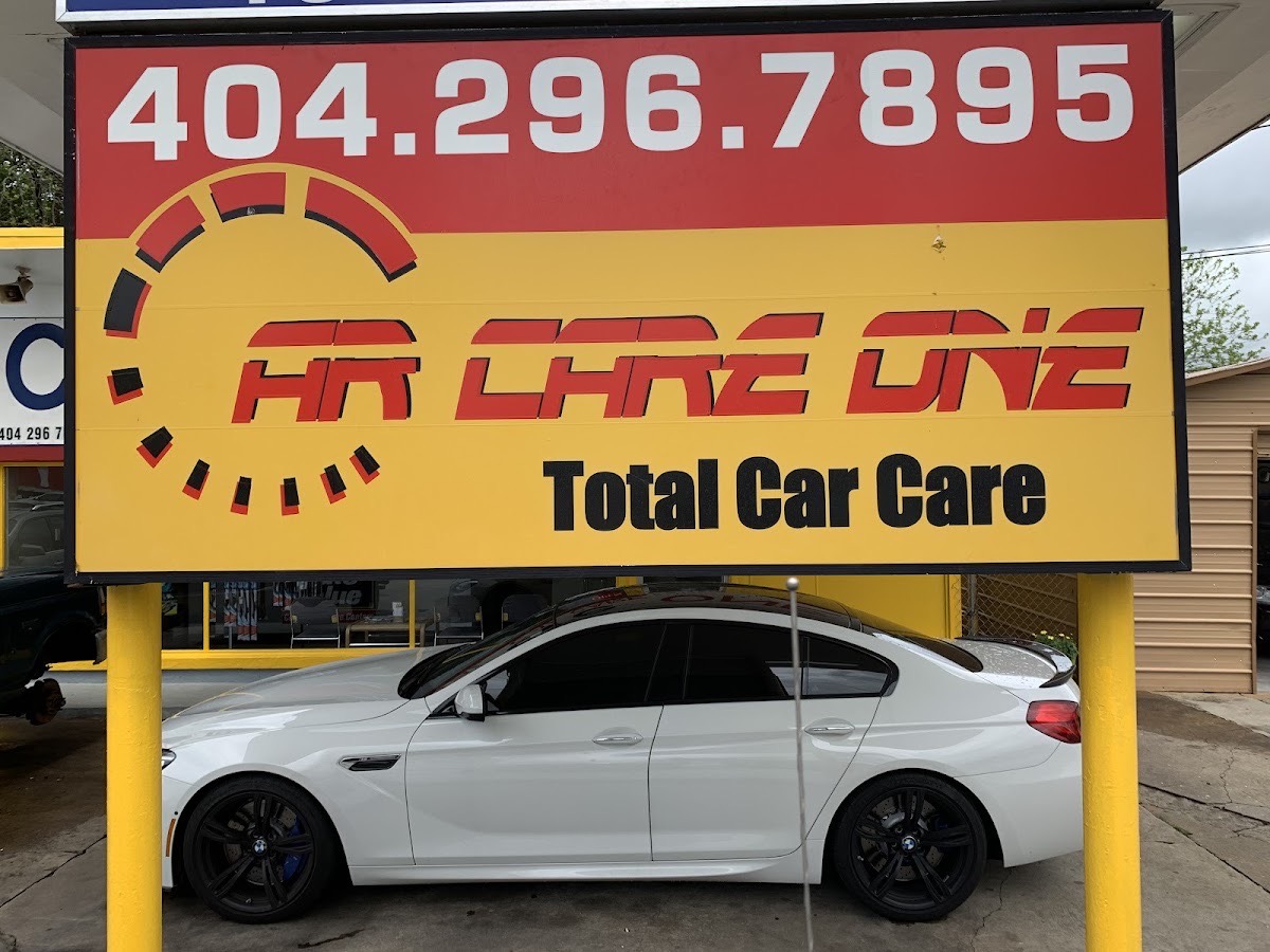 Car Care One — Total Car Care sign at 3404 E Ponce de Leon Ave, Scottdale GA, with a car parked beneath